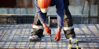 Worker at construction site with rebar