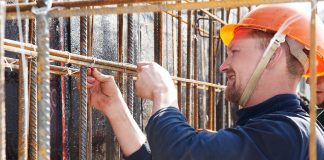 Construction worker tying rebar
