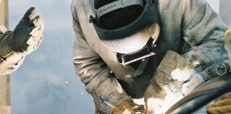 Construction worker welding pipe