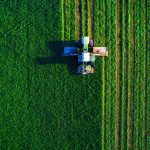 Tractor mowing green field