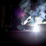 Two welders in manufacturing facility