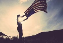 Man Flying American Flag