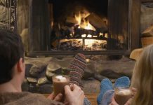 Couple relaxing by a fire