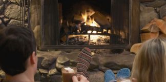 Couple relaxing by a fire