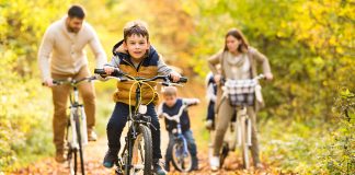 Family riding bikes in the woods