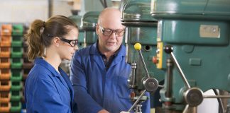 Two machinists working on machine