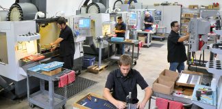 CNC machine shop with lathes, technicians and workers