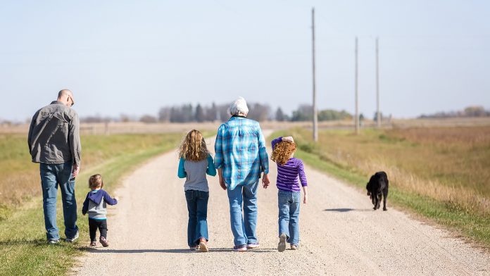 Family Walking Down Rural Gravel Driveway Family Walking Down Rural Gravel Driveway