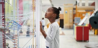 Young Girl Looking At Science Exhibit