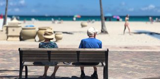 Adults on a beach bench