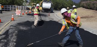 Construction Workers Paving Road